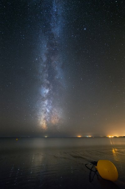 The Milky Way is reflecting on the water of a beach in Morbihan (Brittany, France)